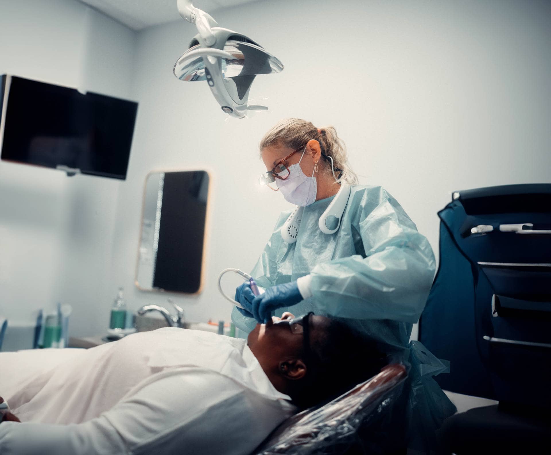 Orthodontist examining patient's teeth
