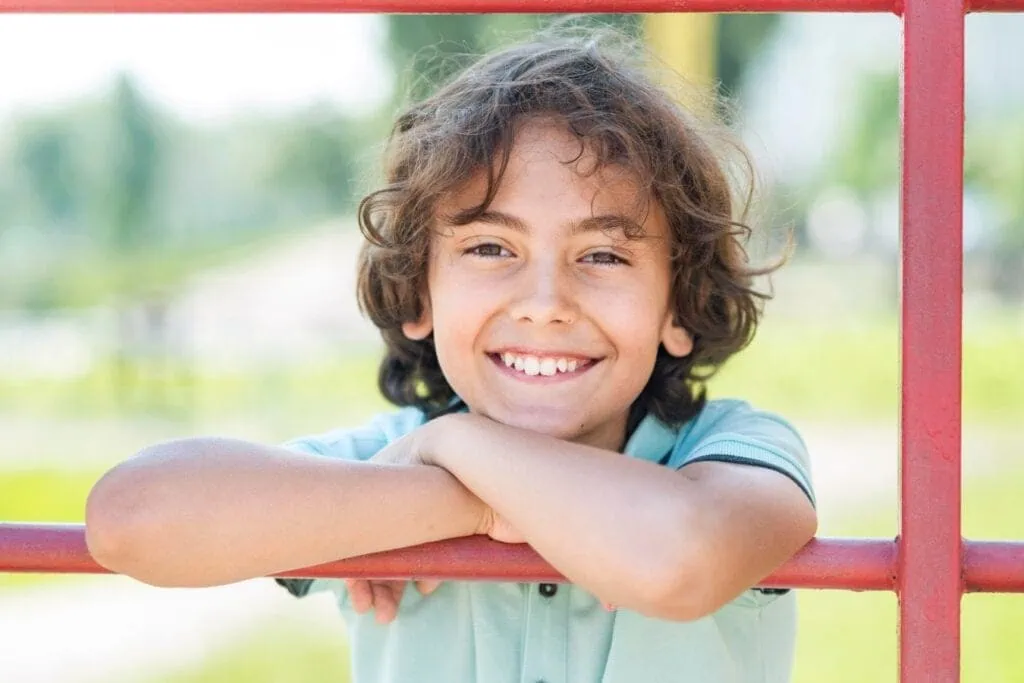 Young boy on playground smiling